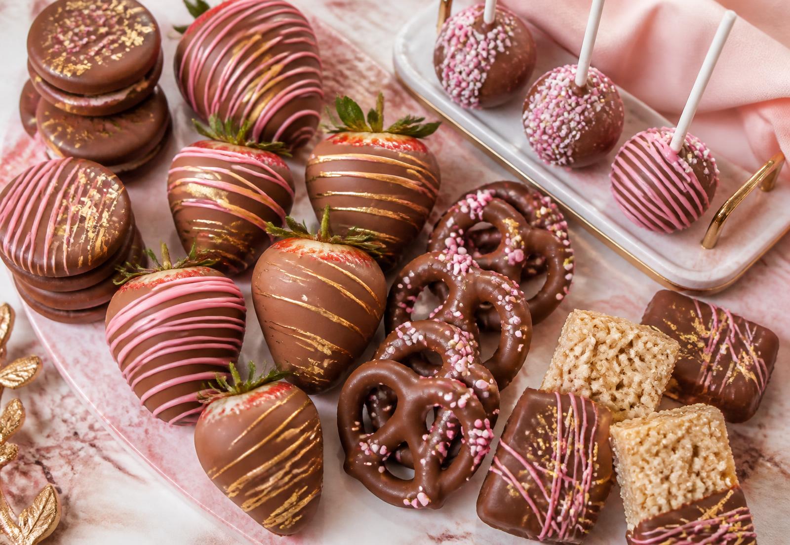 Assorted chocolate covered strawberries, cake pops, Oreos, pretzels and rice krispy treats by Markibella Treats